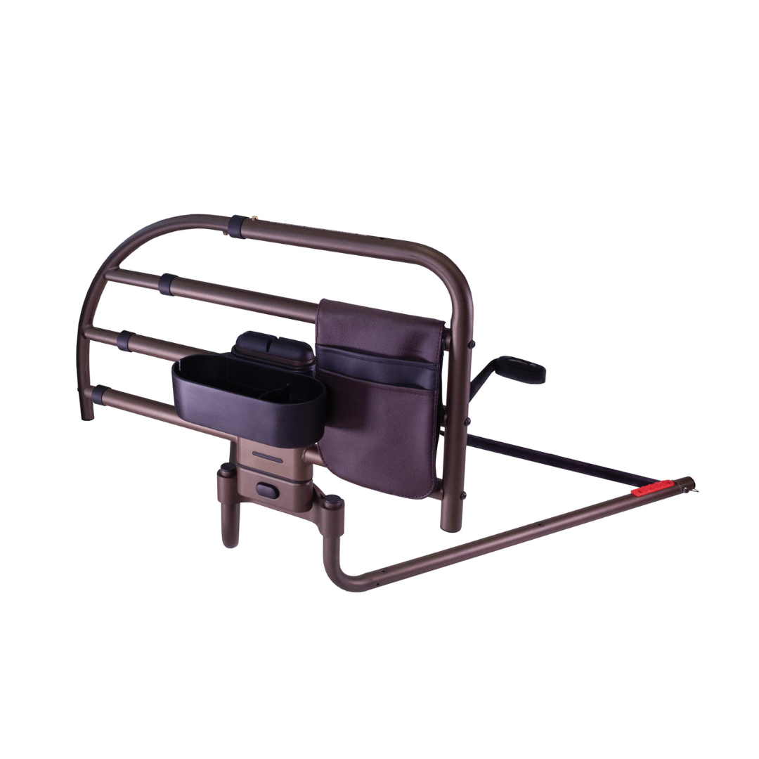 The Signature Life Freedom Click Extendable Bed Rail is a brown adjustable rail with a storage pouch and black cup holder, offering fall protection and assistance for getting in and out of bed.